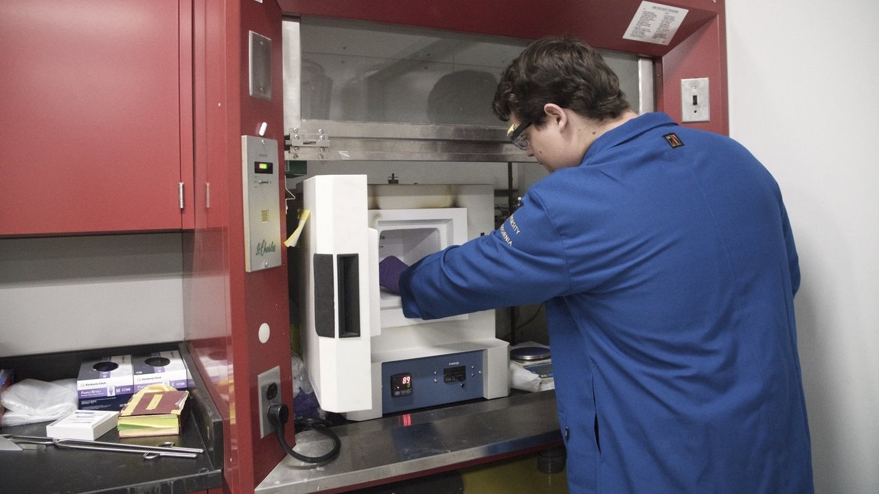 Person in lab works on equipment 