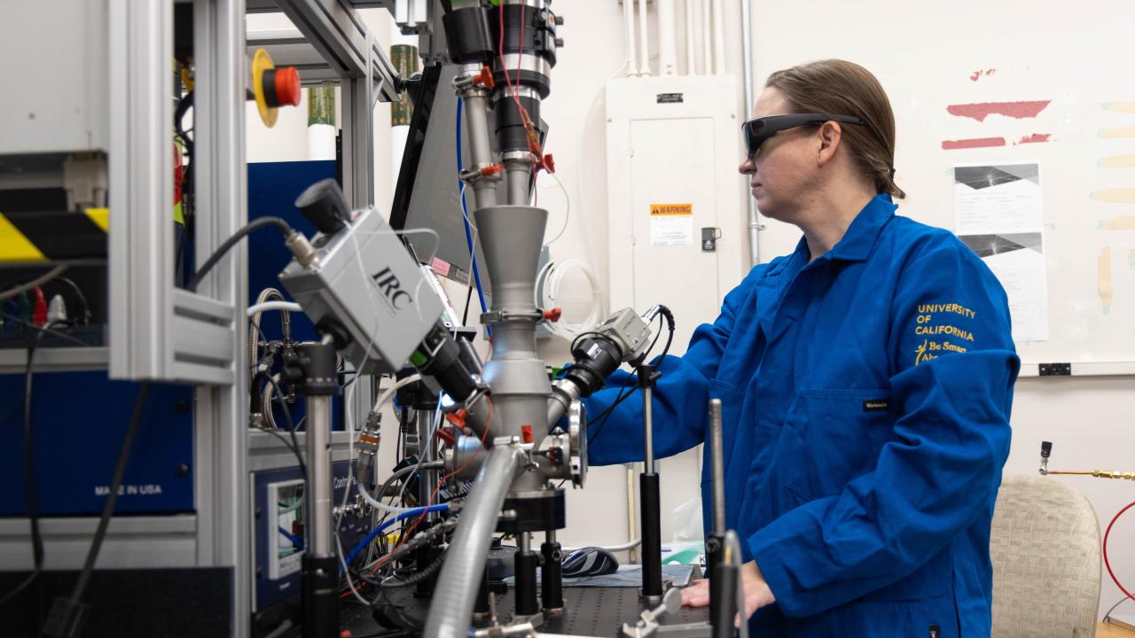 Nicole O'Shea handling lab machinery