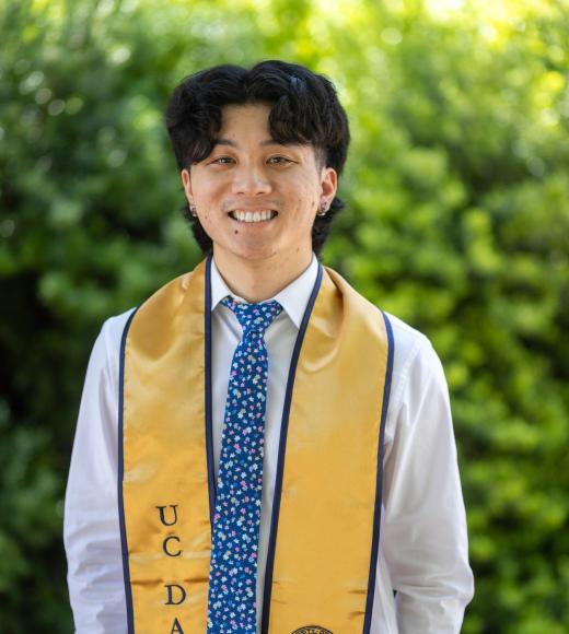 A man wearing a tie smiles