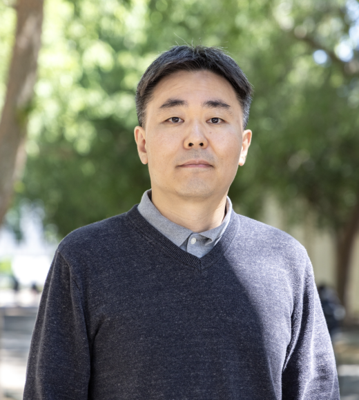 Portrait of Seung Saw Hong, blurred trees in background