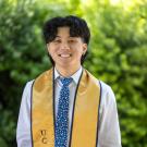 A man wearing a tie smiles